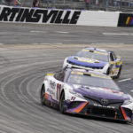 
              Denny Hamlin (11) leads Chase Elliott (9) out of Turn 4 during a NASCAR Cup Series auto race at Martinsville Speedway, Sunday, Oct. 30, 2022, in Martinsville, Va. (AP Photo/Chuck Burton)
            
