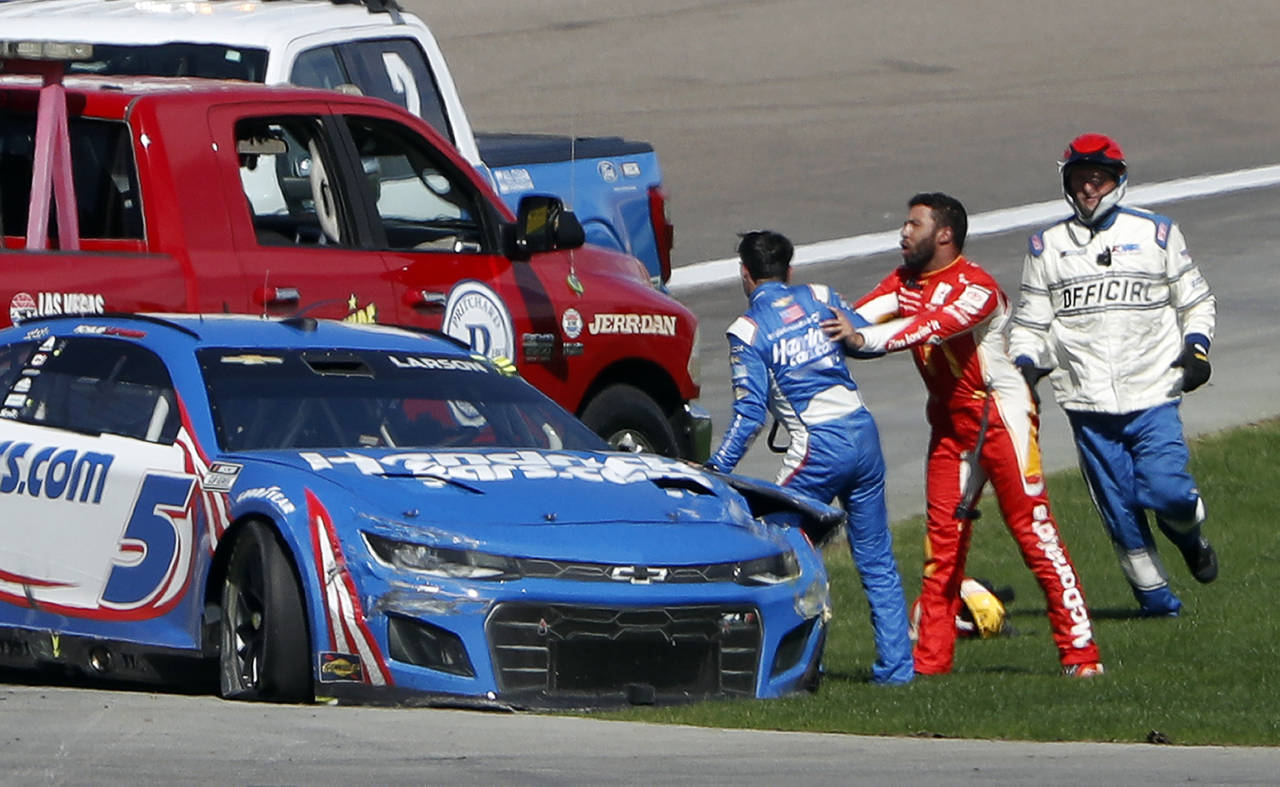 Bubba Wallace, center, shoves Kyle Larson (5), left, after they crashed during a NASCAR Cup Series ...
