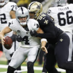 
              New Orleans Saints defensive end Payton Turner (98) sacks Las Vegas Raiders quarterback Derek Carr (4) during the second half of an NFL football game Sunday, Oct. 30, 2022, in New Orleans. (AP Photo/Butch Dill)
            