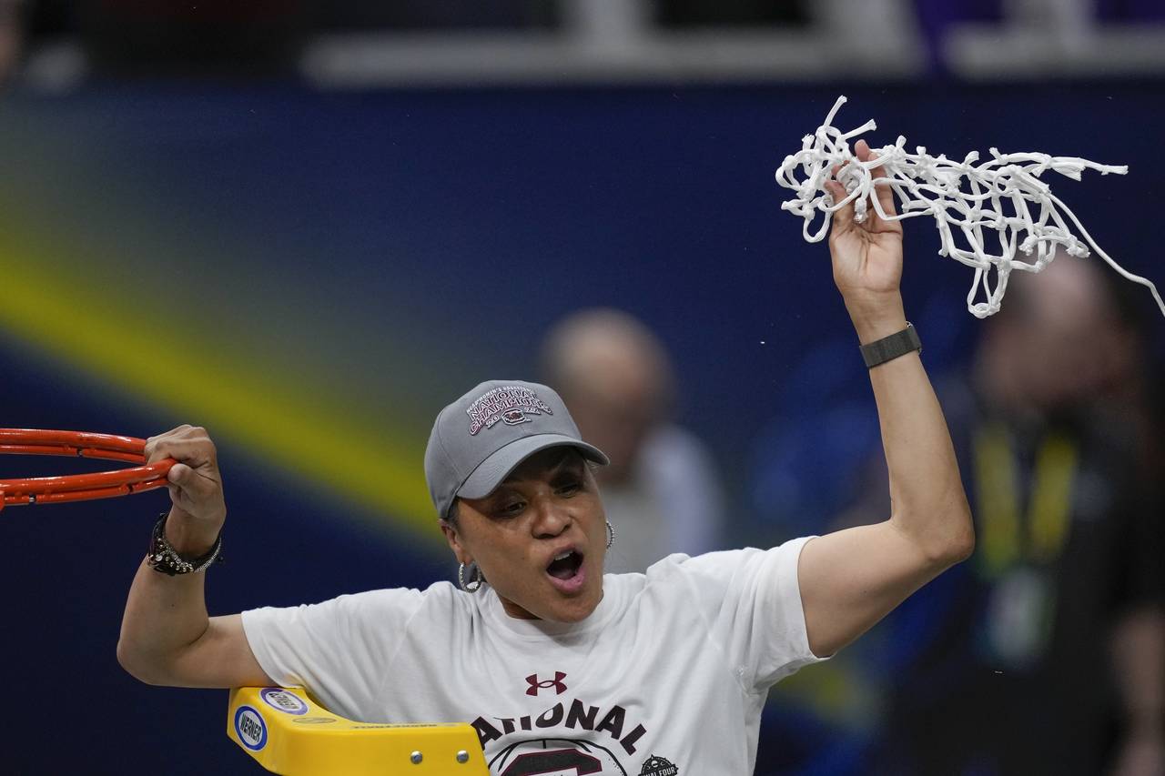 FILE - South Carolina head coach Dawn Staley cuts the net after a college basketball game in the fi...