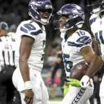 
              Seattle Seahawks quarterback Geno Smith, left, celebrate his touchdown pass to wide receiver Tyler Lockett during an NFL football game against the New Orleans Saints in New Orleans, Sunday, Oct. 9, 2022. (AP Photo/Derick Hingle)
            