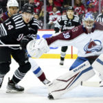 
              Colorado Avalanche goaltender Pavel Francouz (39) tries to block New Jersey Devils right wing Nathan Bastian (14) during the first period of an NHL hockey game, Friday, Oct. 28, 2022, in Newark, N.J. (AP Photo/Julia Nikhinson)
            