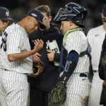 
              New York Yankees relief pitcher Wandy Peralta (58) is checked by a trainer during the third inning of Game 4 of an American League Championship baseball series against the Houston Astros, Sunday, Oct. 23, 2022, in New York. (AP Photo/Seth Wenig)
            