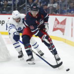 
              Toronto Maple Leafs' David Kampf (64) defends against Winnipeg Jets' Mark Scheifele (55) during the second period of an NHL hockey game Saturday, Oct. 22, 2022, in Winnipeg, Manitoba. (John Woods/The Canadian Press via AP)
            