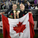 
              Portland Thorns FC forward Christine Sinclair, left, and forward Janine Beckie, right, pose with the Canadian flag after they won the NWSL championship soccer match, Saturday, Oct. 29, 2022, in Washington. Both are from Canada. Portland won 2-0. (AP Photo/Nick Wass)
            