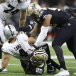 
              New Orleans Saints linebacker Pete Werner (20) sacks Las Vegas Raiders quarterback Derek Carr (4) during the first half of an NFL football game Sunday, Oct. 30, 2022, in New Orleans. (AP Photo/Rusty Costanza)
            