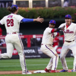 
              The Philadelphia Phillies celebrate a win over the Atlanta Braves after Game 4 of baseball's National League Division Series, Saturday, Oct. 15, 2022, in Philadelphia. The Philadelphia Phillies won, 8-3. (AP Photo/Matt Slocum)
            