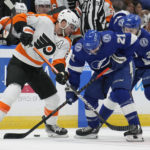 
              Philadelphia Flyers center Scott Laughton, left, battles for the puck with Tampa Bay Lightning center Brayden Point, center, and left wing Brandon Hagel, right, during the first period of an NHL hockey game Tuesday, Oct. 18, 2022, in Tampa, Fla. (AP Photo/Chris O'Meara)
            