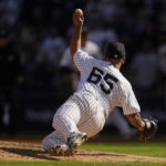 
              New York Yankees starting pitcher Nestor Cortes makes a throw from his knees to get the out at first on Cleveland Guardians Myles Straw to end the top of the fourth inning of Game 2 of an American League Division baseball series, Friday, Oct. 14, 2022, in New York. (AP Photo/John Minchillo)
            