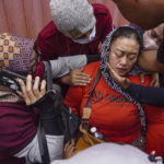 
              A women breaks down after receiving confirmation that her family member is among those killed in a soccer riots, at a hospital in Malang, East Java, Indonesia, Sunday, Oct. 2, 2022. Panic at an Indonesian soccer match Saturday left over 150 people dead, most of whom were trampled to death after police fired tear gas to dispel the riots. (AP Photo/Dicky Bisinglasi)
            