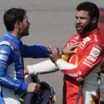 
              Bubba Wallace, right, and Kyle Larson push each other away after the two crashed during a NASCAR Cup Series auto race Sunday, Oct. 16, 2022, in Las Vegas. (AP Photo/John Locher)
            