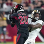 
              Arizona Cardinals cornerback Marco Wilson (20) intercepts a pass intended for New Orleans Saints wide receiver Marquez Callaway, facing camera, which he returned for a touchdown, during the first half of an NFL football game, Thursday, Oct. 20, 2022, in Glendale, Ariz. (AP Photo/Matt York)
            