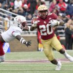 
              Boston College running back Alex Broome (20) side steps a Louisville defenseman during the first half of an NCAA college football game, Saturday, Oct. 1, 2022, in Boston. (AP Photo/Mark Stockwell)
            