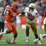 
              Notre Dame running back Audric Estime, right, tries to run past Syracuse linebacker Mikel Jones during the second half of an NCAA college football game in Syracuse, N.Y., Saturday, Oct. 29, 2022. (AP Photo/Adrian Kraus)
            