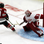 
              Chicago Blackhawks center Andreas Athanasiou (89) skates in against Detroit Red Wings goaltender Alex Nedeljkovic (39) during the second period of an NHL hockey game Friday, Oct. 21, 2022, in Chicago. (AP Photo/David Banks)
            