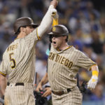 
              San Diego Padres' Jake Cronenworth, right, celebrates his solo home run with Wil Myers during the eighth inning in Game 2 of the baseball team's NL Division Series against the Los Angeles Dodgers, Wednesday, Oct. 12, 2022, in Los Angeles. (AP Photo/Ashley Landis)
            