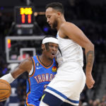
              Oklahoma City Thunder guard Shai Gilgeous-Alexander (2) is defended by Minnesota Timberwolves forward Kyle Anderson (5) during the second half of an NBA basketball game, Wednesday, Oct. 19, 2022, in Minneapolis. (AP Photo/Abbie Parr)
            