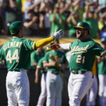 
              Oakland Athletics' Stephen Vogt (21) celebrates with Ernie Clement (44) after hitting a solo home run against the Los Angeles Angels during the seventh inning of a baseball game in Oakland, Calif., Wednesday, Oct. 5, 2022. (AP Photo/Godofredo A. Vásquez)
            