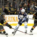 
              Winnipeg Jets left wing Pierre-Luc Dubois (80) passes the puck between Vegas Golden Knights right wing Mark Stone (61) and center Nicolas Roy (10) during the first period in an NHL hockey game, Sunday, Oct. 30, 2022, in Las Vegas. (AP Photo/Ellen Schmidt)
            