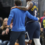 
              Denver Nuggets guard Kentavious Caldwell-Pope is helped off the court after being injured during a drive to the rim against the Los Angeles Lakers in the second half of an NBA basketball game Wednesday, Oct. 26, 2022, in Denver. (AP Photo/David Zalubowski)
            