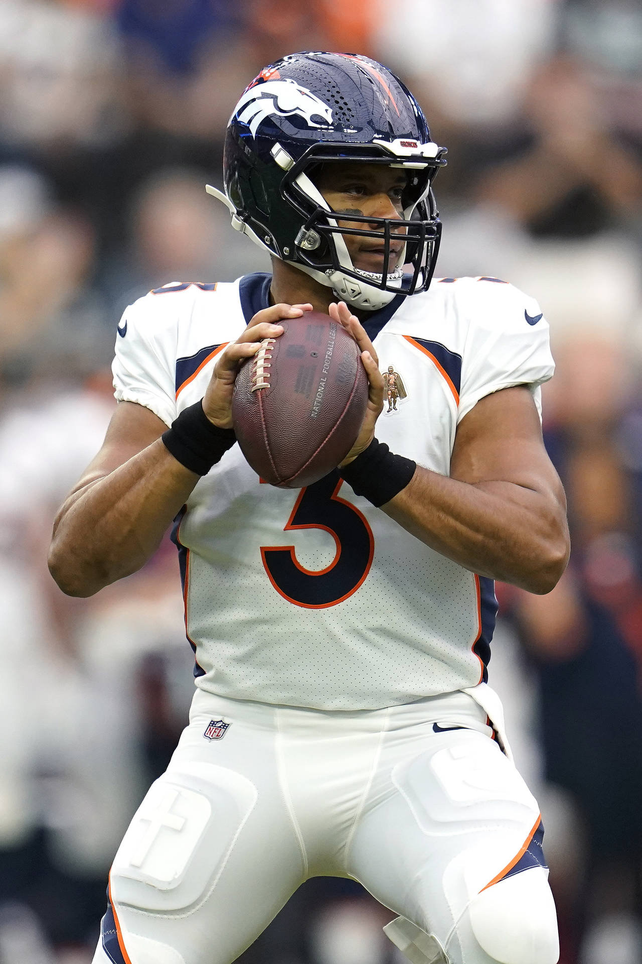 Denver Broncos quarterback Russell Wilson (3) looks to throw during the first half of an NFL footba...