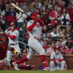 
              Philadelphia Phillies' Kyle Schwarber watches his RBI sacrifice fly against the St. Louis Cardinals during the fifth inning in Game 2 of an NL wild-card baseball playoff series Saturday, Oct. 8, 2022, in St. Louis. (AP Photo/Jeff Roberson)
            
