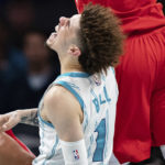 
              Charlotte Hornets guard LaMelo Ball is shaken up on a play in the second half of an NBA preseason basketball game against the Washington Wizards in Charlotte, N.C., Monday, Oct. 10, 2022. (AP Photo/Jacob Kupferman)
            