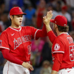 
              Los Angeles Angels' Shohei Ohtani, left, celebrates with pitcher Zack Weiss after the team's win over the Texas Rangers in a baseball game in Anaheim, Calif., Saturday, Oct. 1, 2022. (AP Photo/Ringo H.W. Chiu)
            