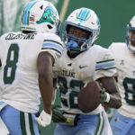 
              Tulane running back Tyjae Spears (22) celebrates his touchdown against South Florida with running back Iverson Celestine (8) and tight end Reggie Brown (89) during the second half of an NCAA college football game Saturday, Oct. 15, 2022, in Tampa, Fla. (AP Photo/Chris O'Meara)
            