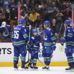 
              Vancouver Canucks' Ilya Mikheyev, of Russia, from left to right, Conor Garland, Jack Rathbone and Brock Boeser celebrate Garland's goal against the Buffalo Sabres during the second period of an NHL hockey game in Vancouver, British Columbia, Saturday, Oct. 22, 2022. (Darryl Dyck/The Canadian Press via AP)
            