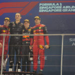 
              Red Bull driver Sergio Perez of Mexico, second from right, poses as he wins the Singapore Formula One Grand Prix beside second place Ferrari driver Charles Leclerc, left, of Monaco and third place Ferrari driver Carlos Sainz, right, of Spain at the Marina Bay City Circuit in Singapore, Sunday, Oct. 2, 2022. (AP Photo/Vincent Thian)
            