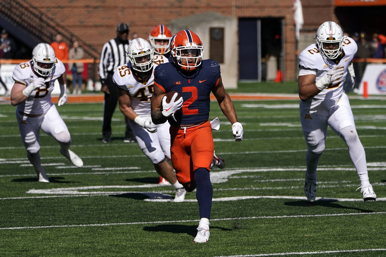 Illinois running back Chase Brown carries the ball during the second half of an NCAA college footba...