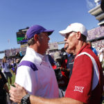 
              TCU head coach Sonny Dykes, left, meets Oklahoma head coach Brent Venables on the field following TCU's 55-24 win over Oklahoma in an NCAA college football game Saturday, Oct. 1, 2022, in Fort Worth, Texas. (AP Photo/Ron Jenkins)
            