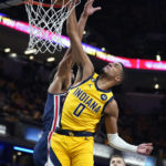
              Indiana Pacers' Tyrese Haliburton (0) dunks against Washington Wizards' Anthony Gill during the second half of an NBA basketball game Wednesday, Oct. 19, 2022, in Indianapolis. (AP Photo/Michael Conroy)
            