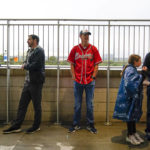 
              Fans cover up from rain during a rain delay at Truist Park before Game 2 of baseball's National League Division Series between the Atlanta Braves and the Philadelphia Phillies, Wednesday, Oct. 12, 2022, in Atlanta. (AP Photo/Brynn Anderson)
            