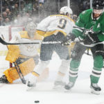 
              Dallas Stars center Tyler Seguin (91) tries to take control of the puck in front of Nashville Predators left wing Filip Forsberg (9) and goaltender Juuse Saros (74) during the first period of an NHL hockey game in Dallas, Saturday, Oct. 15, 2022. (AP Photo/LM Otero)
            