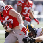 
              Ohio State linebacker Tommy Eichenberg, left, scores a touchdown after intercepting a pass against Iowa during the first half of an NCAA college football game Saturday, Oct. 22, 2022, in Columbus, Ohio. (AP Photo/Jay LaPrete)
            