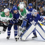 
              Toronto Maple Leafs goaltender Ilya Samsonov (35) looks for the puck as Dallas Stars' Mason Marchment (27) and Jamie Benn (14) check Maple Leafs' Rasmus Sandin (38) in front of the net during the first period of an NHL hockey game Thursday, Oct. 20, 2022, in Toronto. (Cole Burston/The Canadian Press via AP)
            