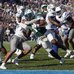 
              Tulane running back Shaadie Clayton (0) breaks free from Memphis linebacker Geoffrey Cantin-Arku (9) to score a touchdown during the first half of an NCAA college football game in New Orleans, Saturday, Oct. 22, 2022. (AP Photo/Tyler Kaufman)
            