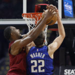 
              Cleveland Cavaliers center Evan Mobley (4) blocks a shot by Orlando Magic forward Franz Wagner (22) during the first half of a NBA basketball game, Wednesday, Oct. 26, 2022, in Cleveland. (AP Photo/Ron Schwane)
            