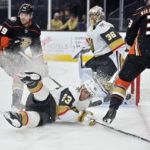 
              Vegas Golden Knights Alec Martinez (23) falls to the ice while defending against the Anaheim Ducks during the first period of an NHL hockey game Friday, Oct. 28, 2022, in Las Vegas. (AP Photo/David Becker)
            