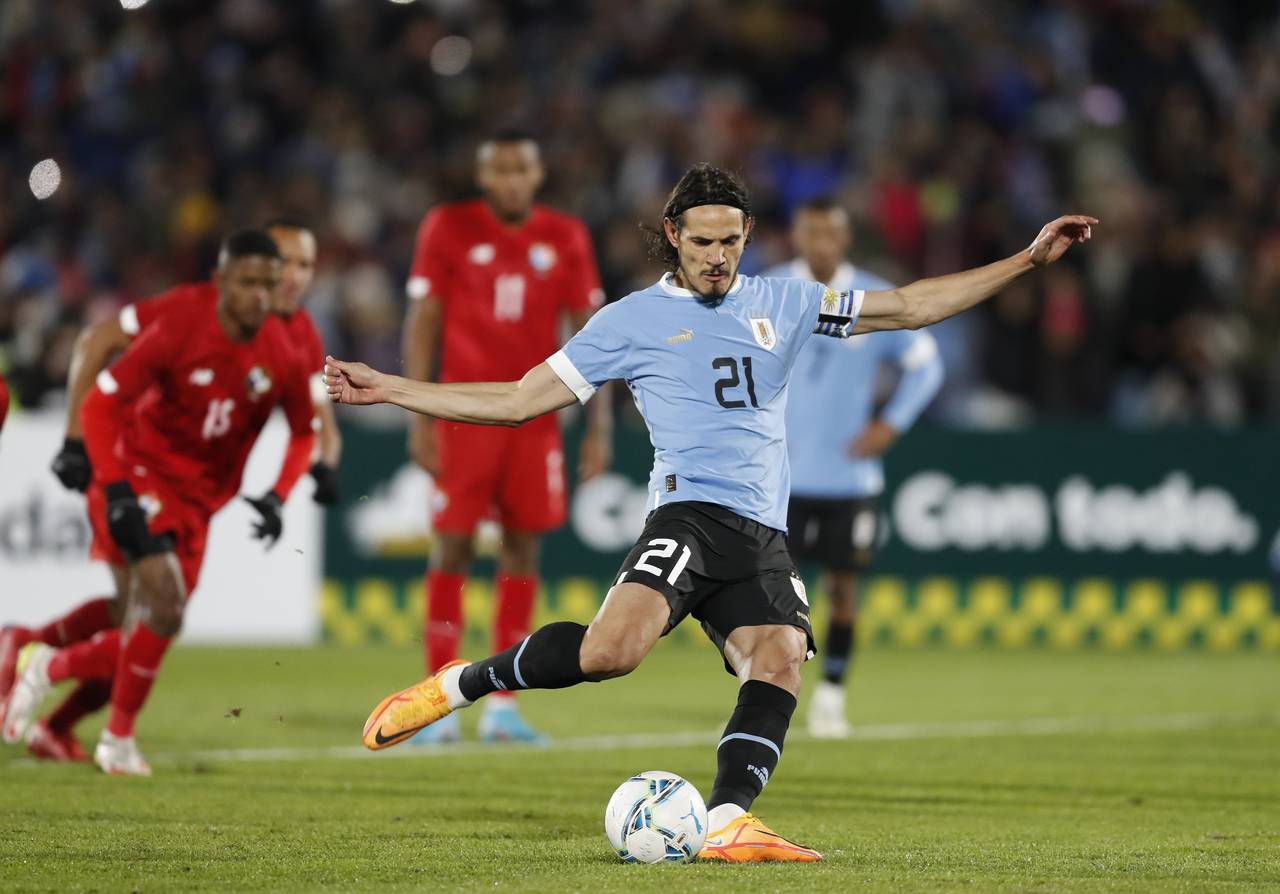 FILE - Uruguay's Edinson Cavani kicks a penalty shot and scores during a friendly soccer match agai...