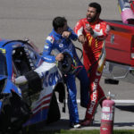 
              Bubba Wallace, right, pushes Kyle Larson after the two crashed during a NASCAR Cup Series auto race Sunday, Oct. 16, 2022, in Las Vegas. (AP Photo/John Locher)
            