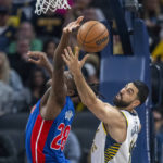 
              Detroit Pistons center Isaiah Stewart, left, and Indiana Pacers center Goga Bitadze reach for a rebound during the first half of an NBA basketball game in Indianapolis, Saturday, Oct. 22, 2022. (AP Photo/Doug McSchooler)
            