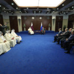 
              Russian President Vladimir Putin, background right, and the Emir of Qatar, Sheikh Tamim bin Hamad Al Thani, foreground left, talk to each other during their meeting on sidelines of the Conference on Interaction and Confidence Building Measures in Asia (CICA) summit, in Astana, Kazakhstan, Thursday, Oct. 13, 2022. (Vyacheslav Prokofyev, Sputnik Kremlin/Pool Photo via AP)
            