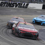 
              Ross Chastain (1) leads Kevin Harvick (4) and Daniel Suarez (99) out of Turn 4 during a NASCAR Cup Series auto race at Martinsville Speedway, Sunday, Oct. 30, 2022, in Martinsville, Va. (AP Photo/Chuck Burton)
            