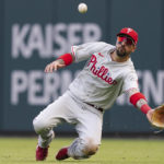 
              Philadelphia Phillies right fielder Nick Castellanos (8) makes a diving catch against Atlanta Braves catcher William Contreras during the ninth inning in Game 1 of a National League Division Series baseball game, Tuesday, Oct. 11, 2022, in Atlanta. The Philadelphia Phillies won 7-6. (AP Photo/John Bazemore)
            
