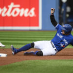 
              Toronto Blue Jays' George Springer slides safely into second base as Boston Red Sox center fielder Enrique Hernandez attempts to tag during first inning of a baseball game in Toronto on Saturday, Oct. 1, 2022. (Christopher Katsarov/The Canadian Press via AP)
            