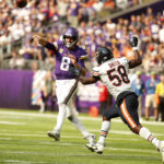 
              Minnesota Vikings quarterback Kirk Cousins (8) throws a pass over Chicago Bears linebacker Roquan Smith (58) during the second half of an NFL football game, Sunday, Oct. 9, 2022, in Minneapolis. (AP Photo/Bruce Kluckhohn)
            