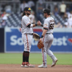 
              San Francisco Giants' Brandon Crawford, left, and Ford Proctor celebrate after the team defeated the San Diego Padres in a baseball game, Wednesday, Oct. 5, 2022, in San Diego. (AP Photo/Derrick Tuskan)
            